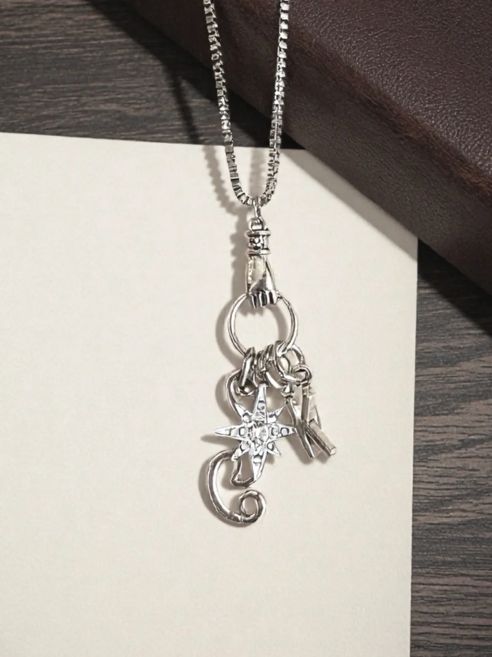Monk DND necklace with the wind, a star, and KI Dungeons and Dragons jewelry
